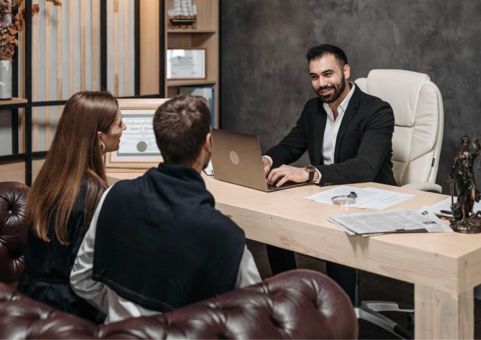 Lawyer using digital tools to consult clients in a modern office setting.