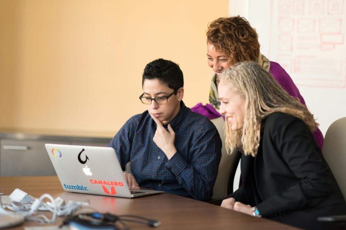 Startup team working together on software development project.