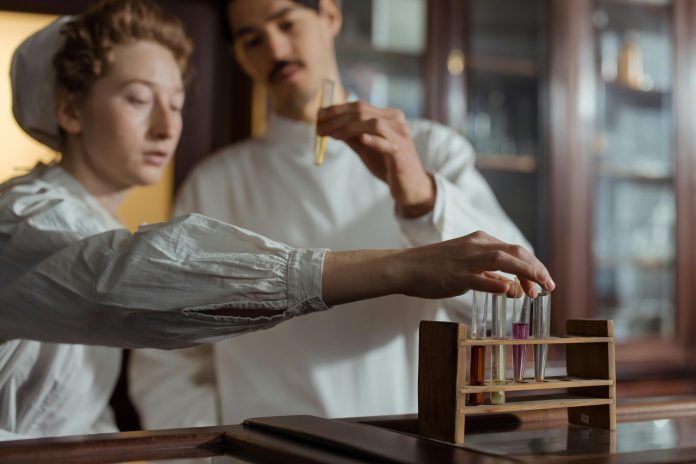 Scientists analyzing test tubes in a lab, symbolizing pharmaceutical innovation.